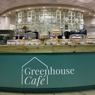 The Greenhouse Café at Sherfield-on-Loddon Garden Centre counter showing a selection of cakes and baked goods available for sale.