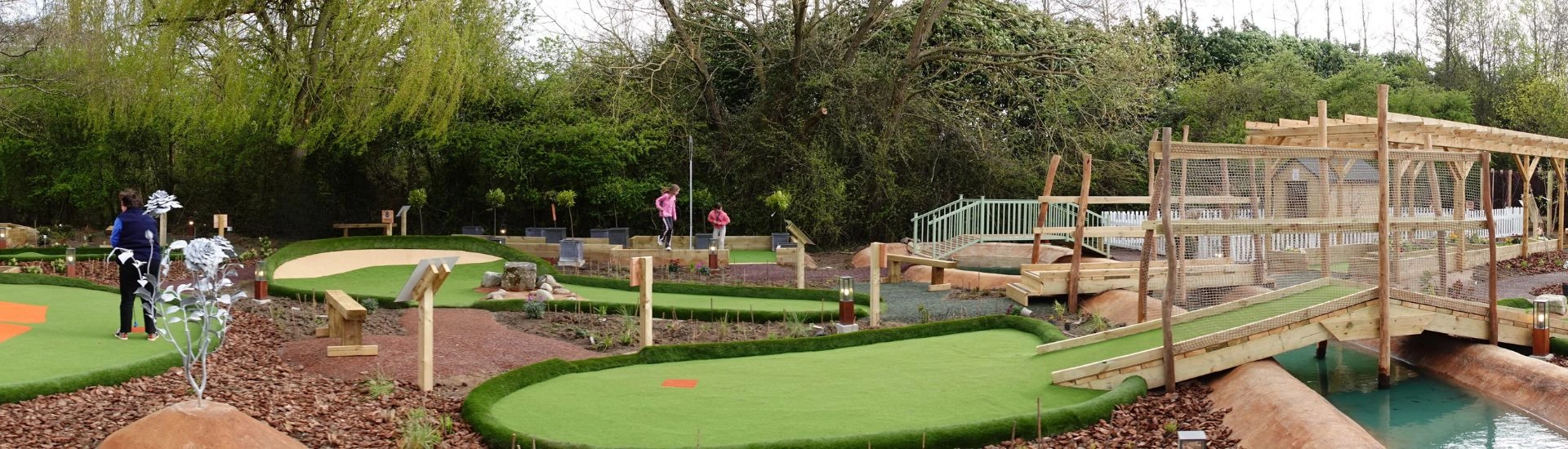 Adventure golf course at Sherfield-on-Loddon near Basingstoke with landscaped mini golf holes, wooden bridges and water features