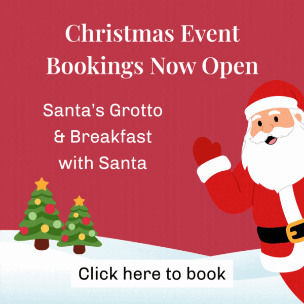 Illustration of Santa waving beside two decorated Christmas trees in the snow, with text reading Christmas Event Bookings Now Open, Santa's Grotto & Breakfast with Santa, and Click here to book